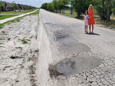 Molly shows pothole repair needed