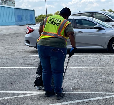 Cleaning up parking lot after 2022 flooding.