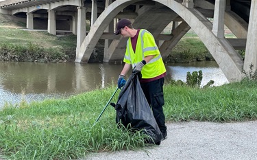 Picking up after flood of 2022 near riverbanks.