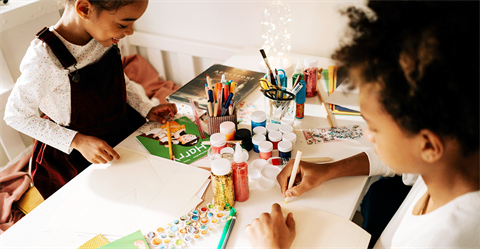 Mom and daughter doing arts and crafts together.