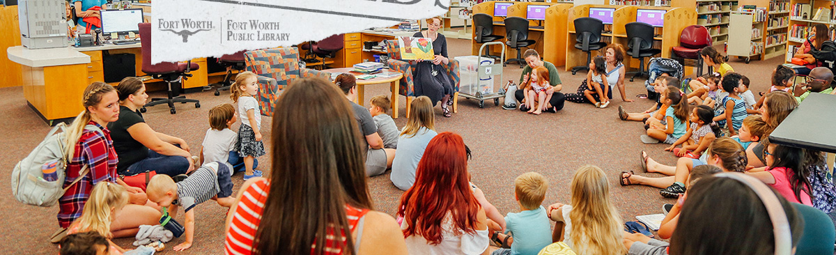 large group of children and parents in circle for story time