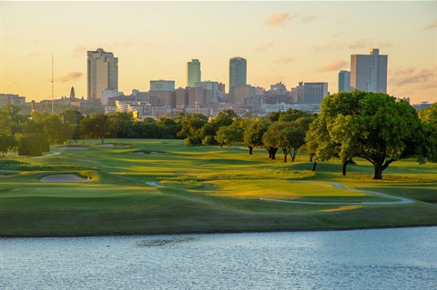 an image of the golf course with the downtown skyline in the background