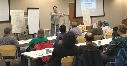 a man gives a presentation to a classroom of people