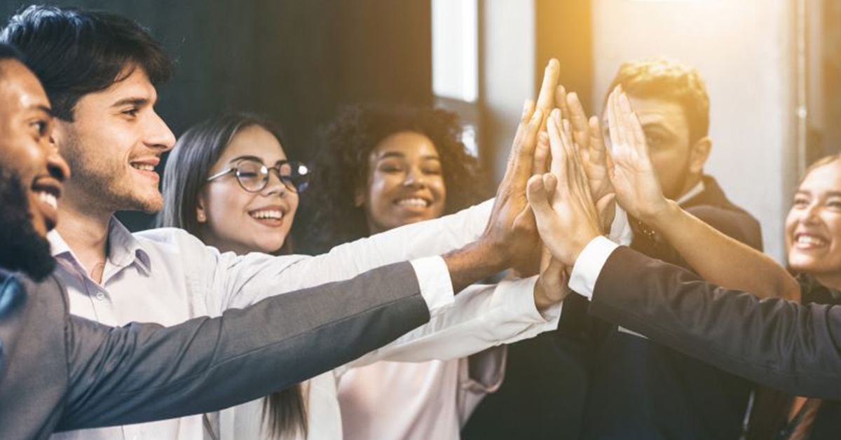 A group of people high-fiving each other