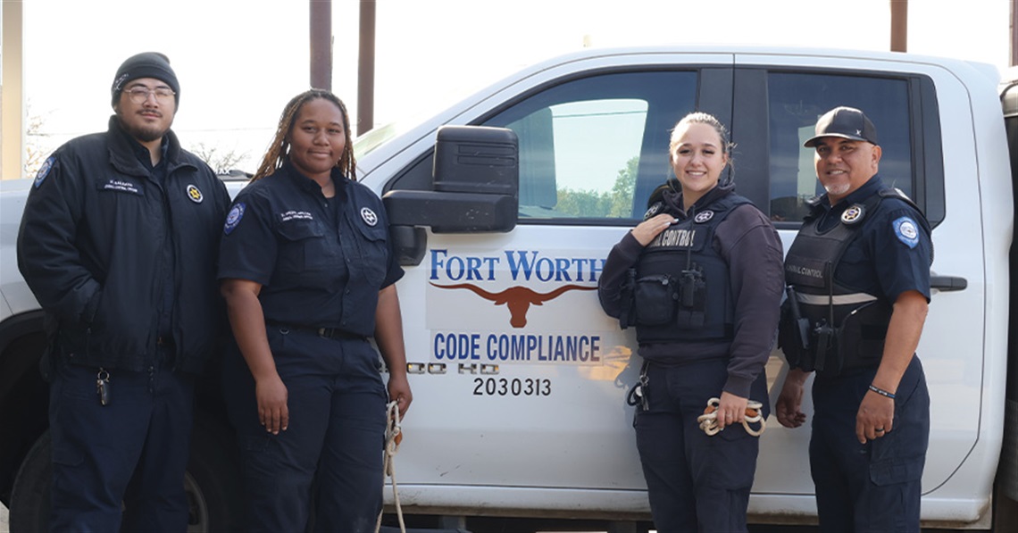 four animal control officers in front of their truck