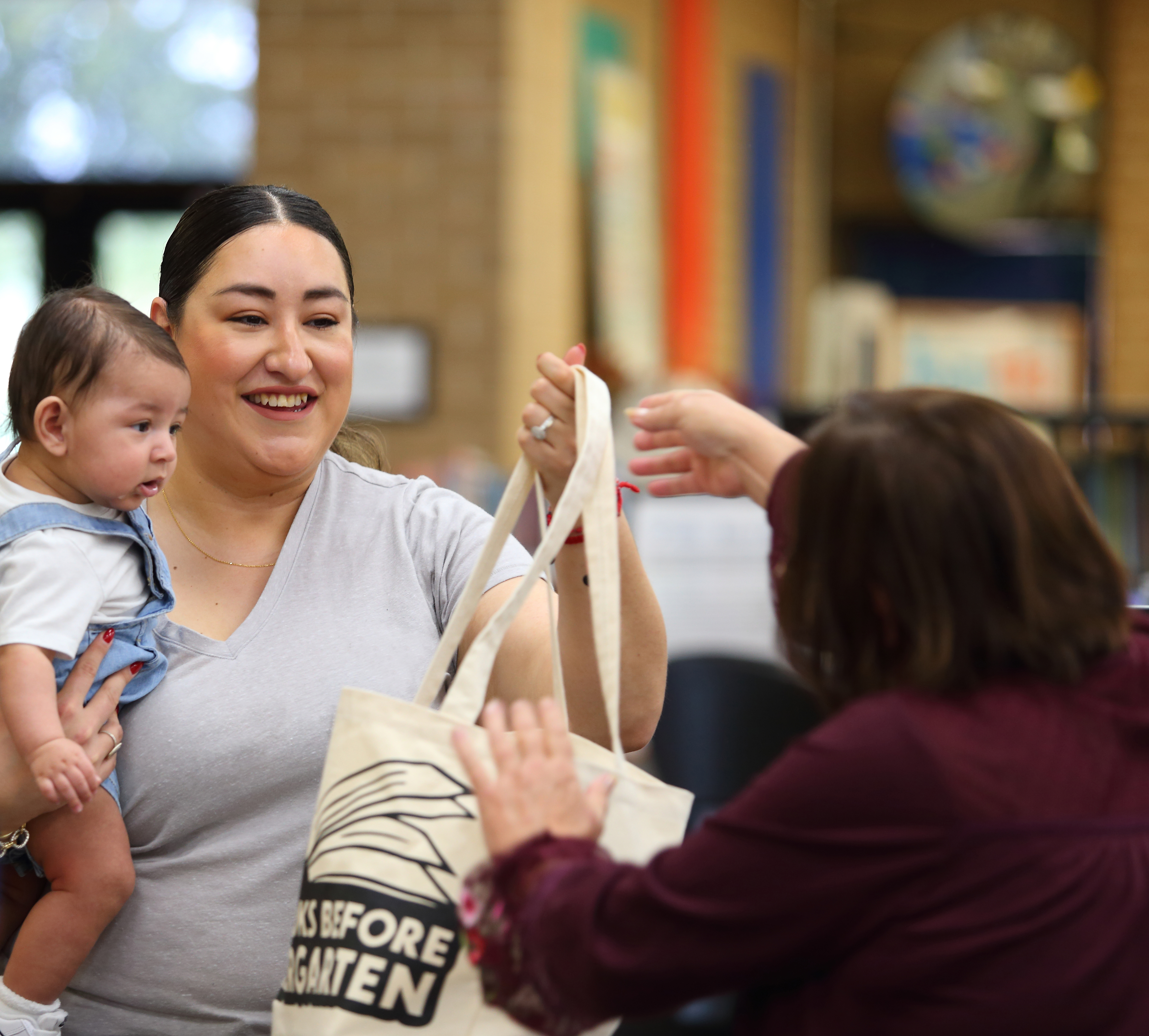 mom and baby receive free tote bag