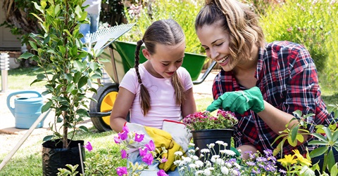 a woman and daughter working in the garden