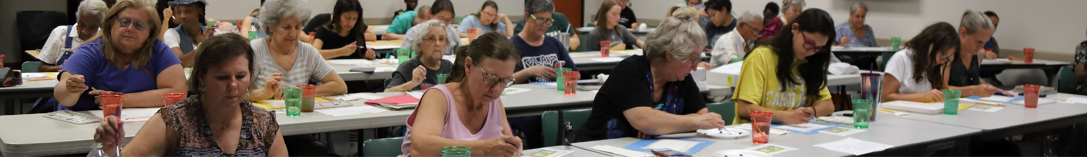 A picture of several people participating in a watercolor class.