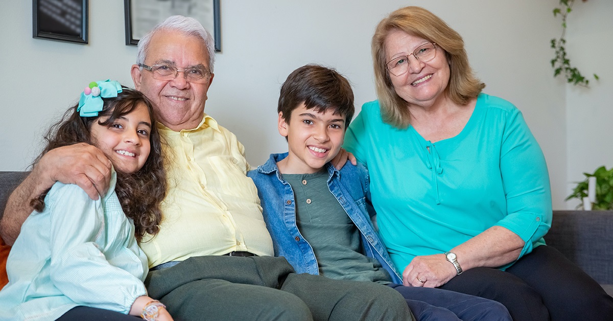 grandparents sitting on a couch with grandkids