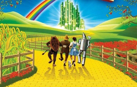four friends and theirsmall dog skipping down a yellow brick rod to a large green fortress