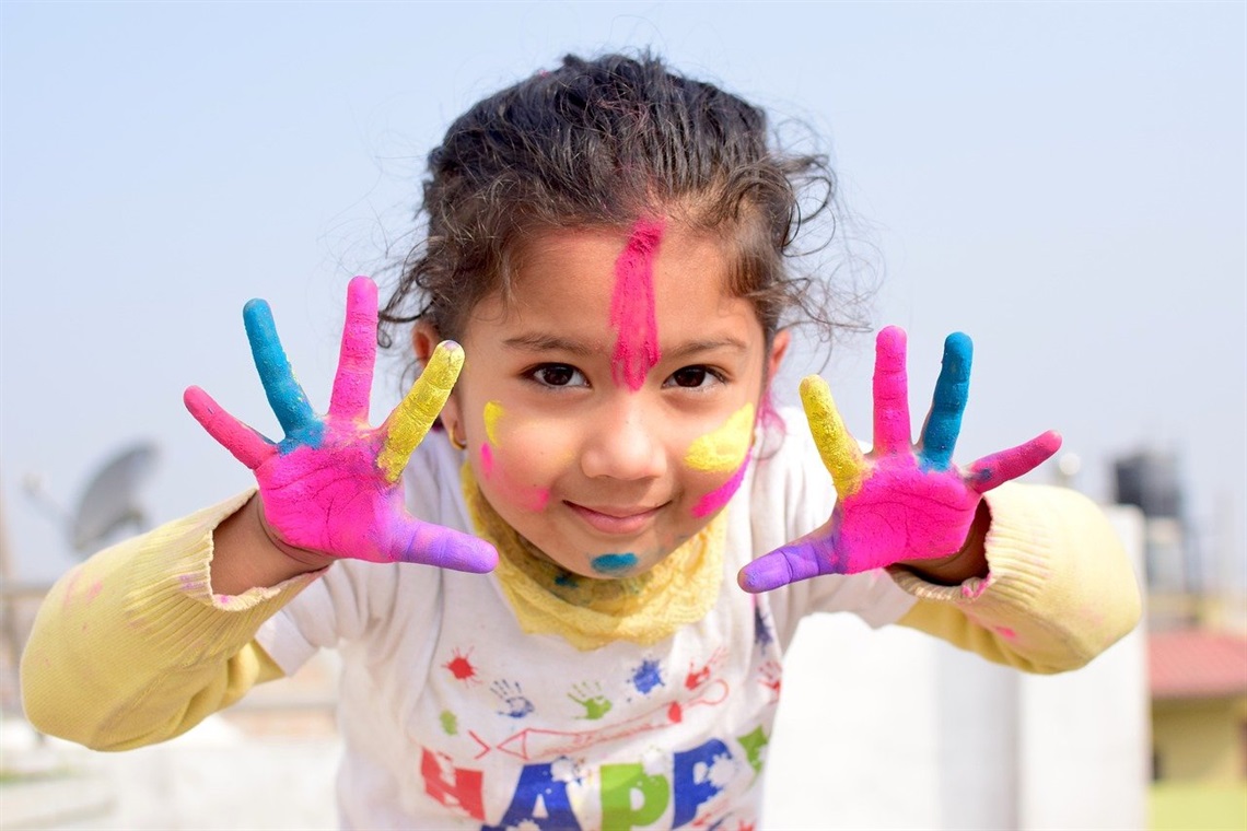 small child with paint on their hands
