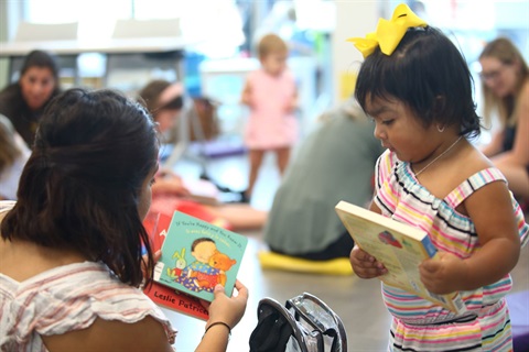 Mom and Baby holding books