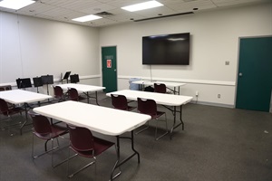 photo of meeting room at diamond hill jarvis featuring tables, chairs and video screen