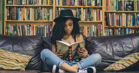 teenager reading on a couch