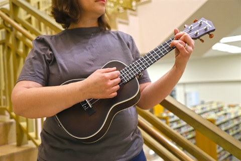 woman playing ukulele