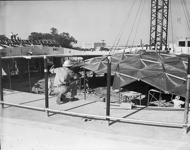 A foreman watches as construction workers add more sections to Casa Mañana's aluminum dome. Work on the dome was expected to end within four days, after which a helicopter was set to place a ventilator on top. (Photo: Fort Worth Star-Telegram Collection, University of Texas at Arlington Libraries)