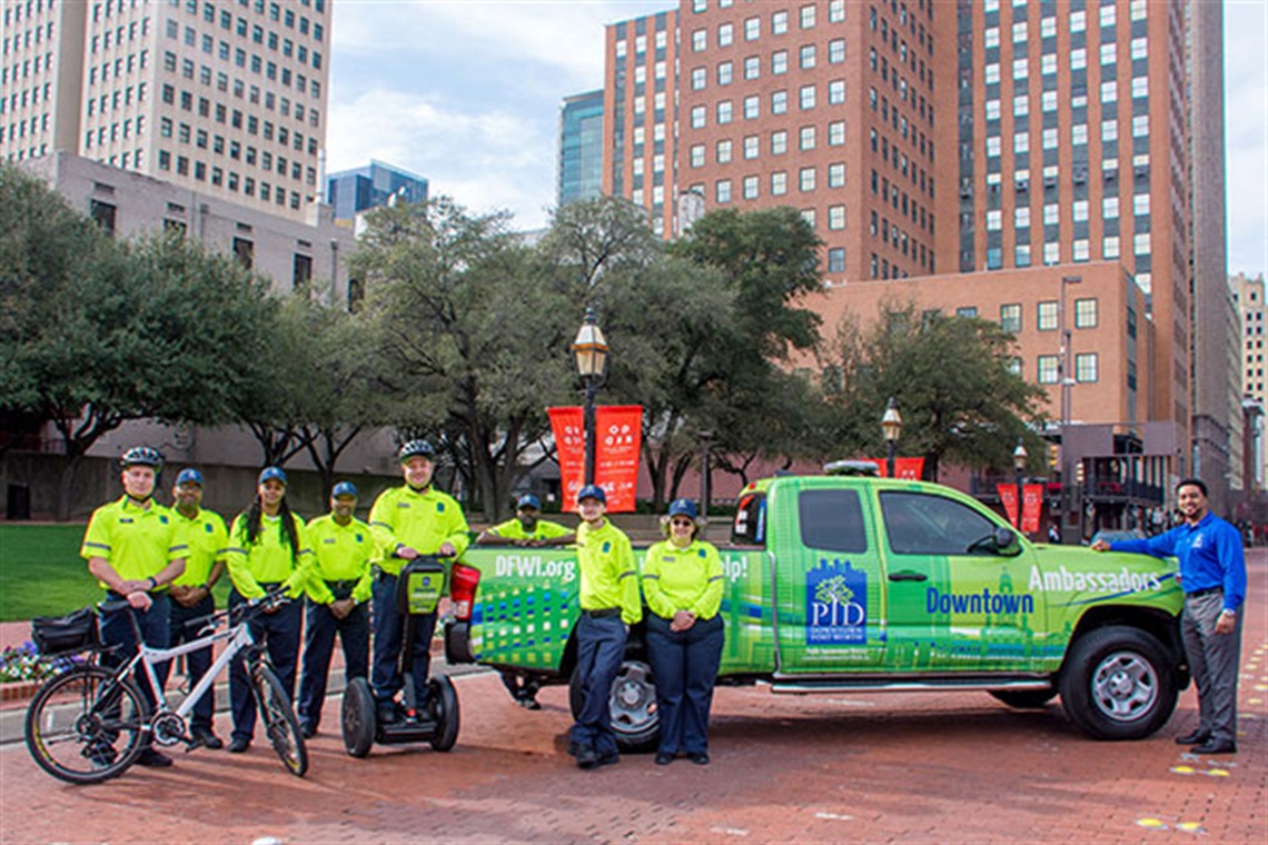 the downtown ambassadors take a group photo in General Worth's square