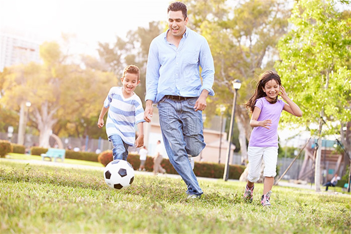 Family playing soccer