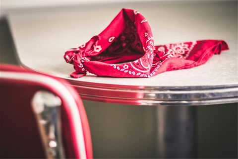 A red bandana sits on a white, diner-style table.