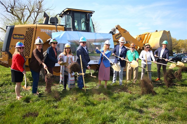 Ten City of Fort Worth employees, including Mayor Mattie Parker and Library Director Midori Clark, stand outside holding shovels. They are celebrating the groundbreaking of the new Far Northwest Library Branch.