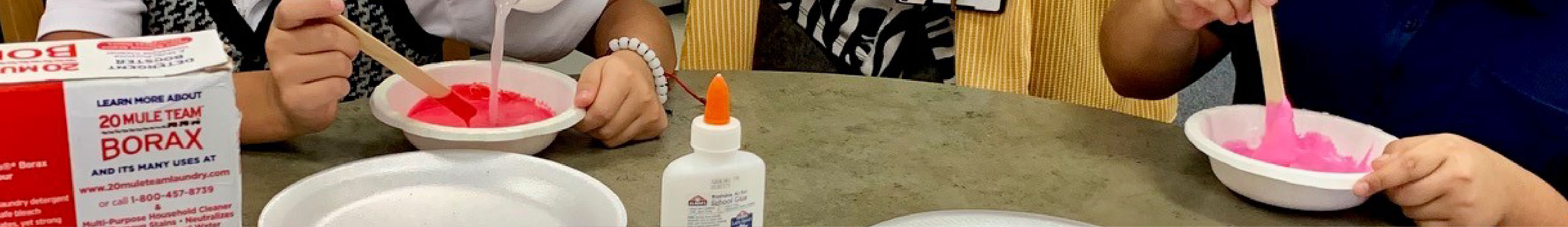 Two teens engage in a STEAM activity.