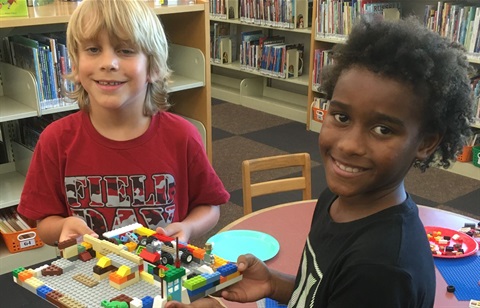 Photo of two boys building things in the library