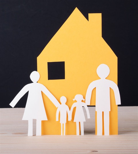 Homeless System paperdoll of family in front of cut out of  house 