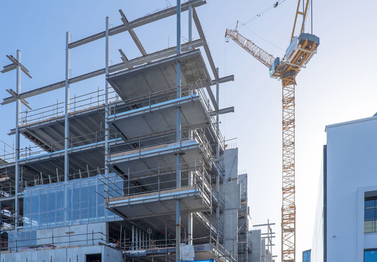 Commercial permitting high-rise building being built with crane